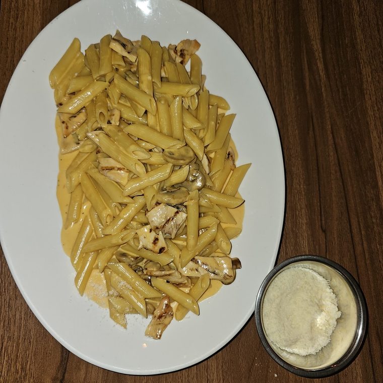 Creamy chicken penne with a side pot of sauce