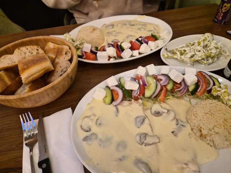 Bread basket with Greek salad and a chicken main